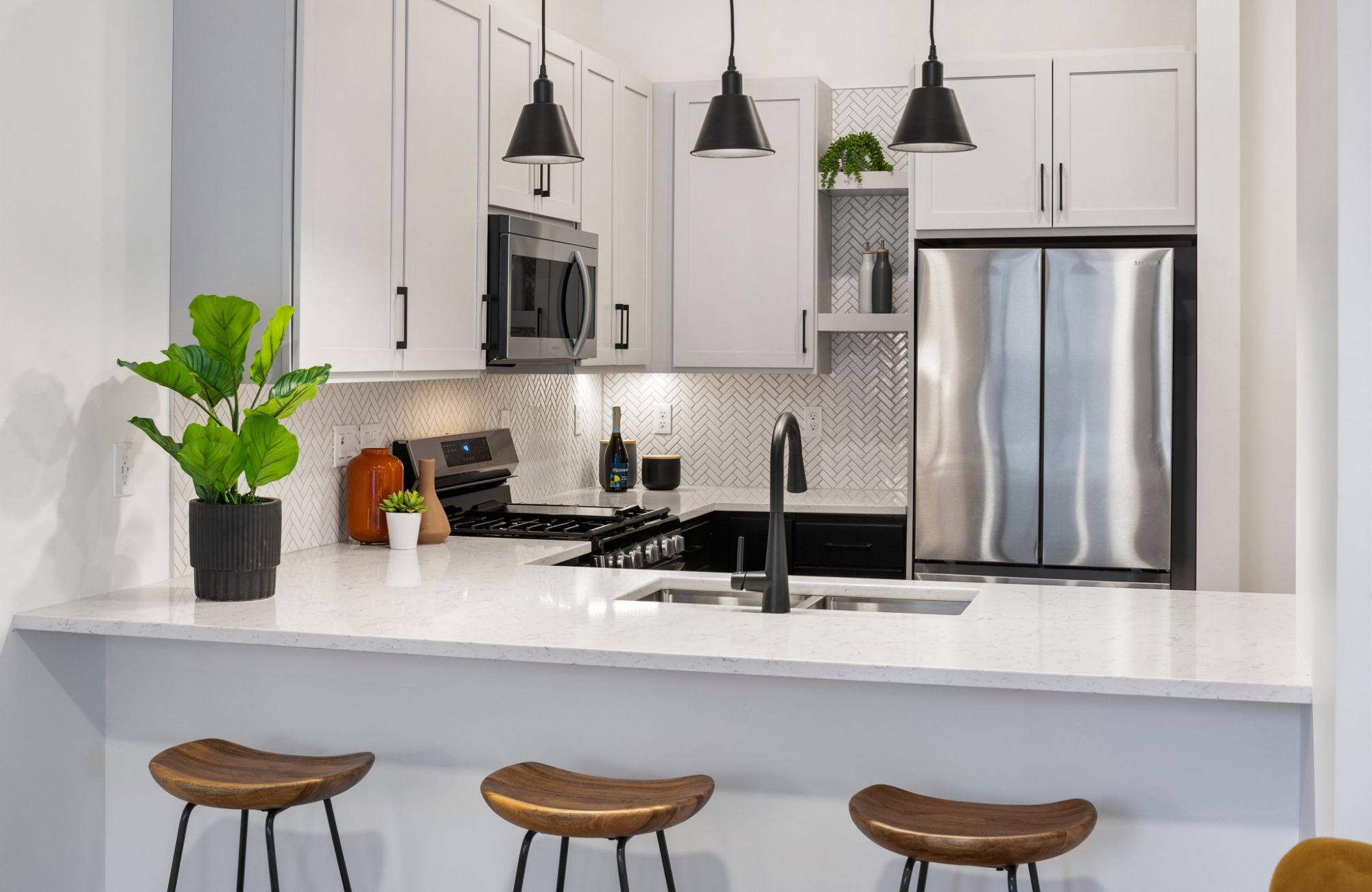 Moment apartments look into kitchen with peninsula and seating