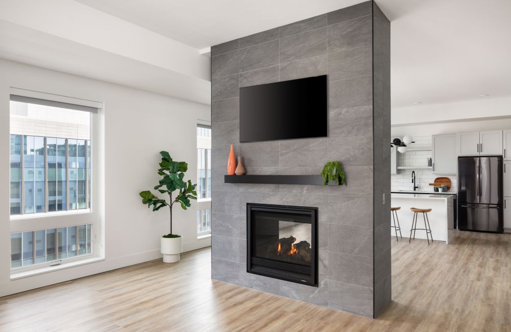 Moment Apartments penthouse showing a tall double sided fireplace with lots of natural light