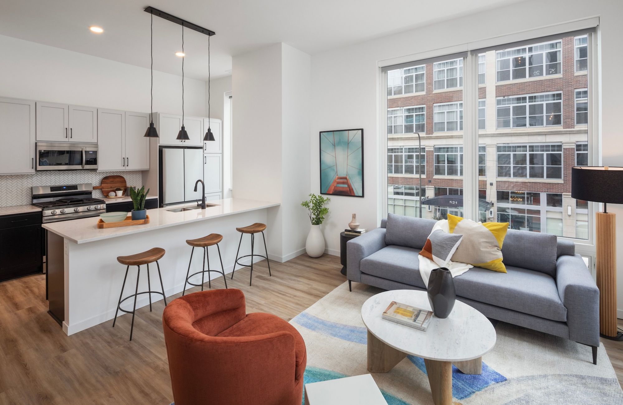 Moment Minneapolis apartments open floor plan layout with colorful furniture and lots of natural light